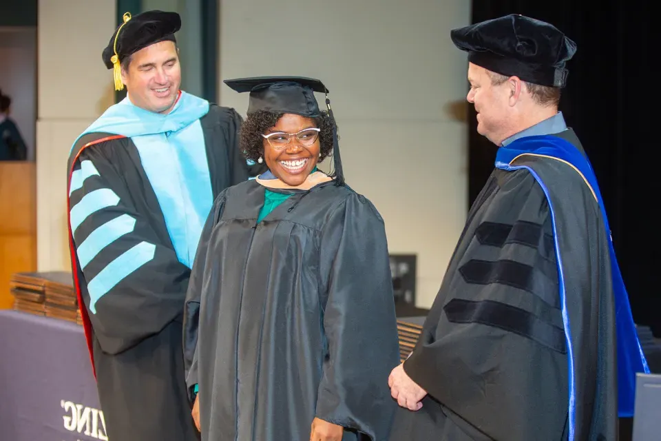 Herzing University Graduate Smiling at Ceremony